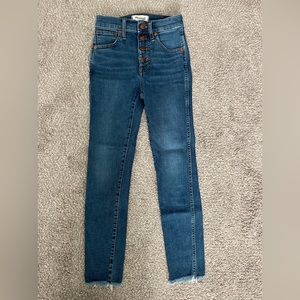 Madewell jeans. Size 23P. 10” High Rise Skinny. Mid wash. Raw hem. Button fly.